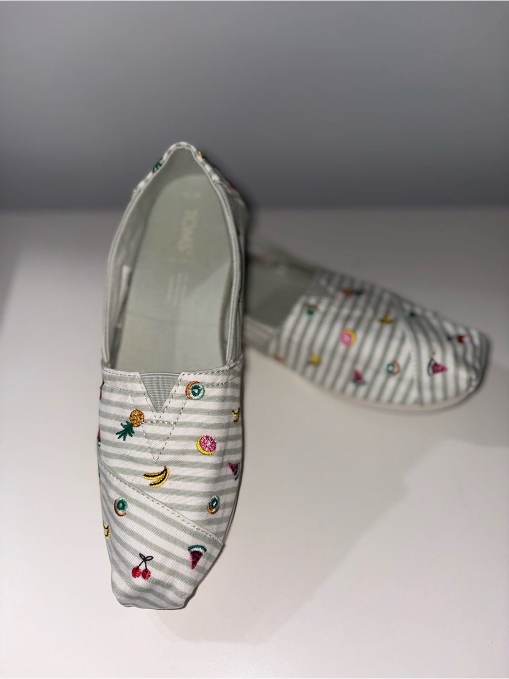 Toms womens Slip-On Shoes in White and Light Gray with Colorful Fruit Embroidery